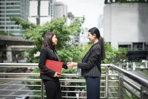 Business women shake hands photo