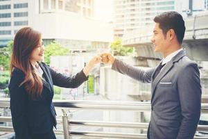 Business people giving fist bump photo
