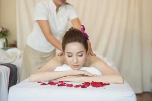 Young beautiful woman with healthy massage in a spa salon photo