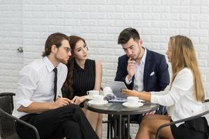 Group of young business co-workers in discussion at office