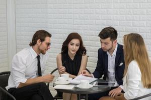 Group of young business co-workers in discussion at office