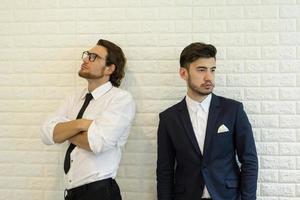 Two businessmen standing in office photo