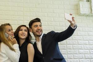 Business people taking selfie while working at office photo