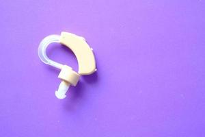 Hearing aid equipment on purple background photo