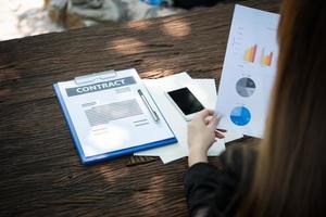 Business woman working with documents and graphs photo