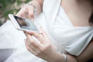 Girl sitting with smartphone in hands photo