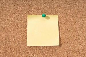 Cork board with blank yellow note for adding text photo