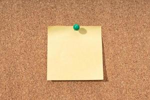 Cork board with blank yellow note for adding text photo