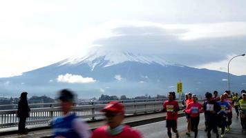 Timelapse crowd people running marathon with Mountain Fuji background