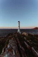 A lighthouse on the spanish coast during the witching hour on wide angle photo