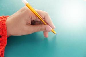 Close up of a woman's hand writing photo