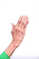 Elderly woman's hand on white background photo