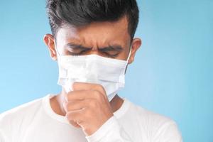 Man coughing with a mask on photo