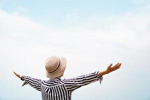 Man raises hands up to the sky photo