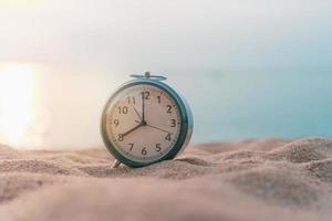 Selective focus of alarm clock with nature background photo