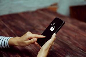 Woman using a smartphone with technology icons in the background photo