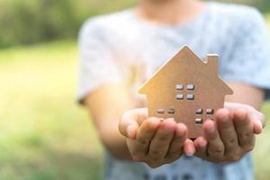 Copyspace model of a little house in the hands of a woman photo