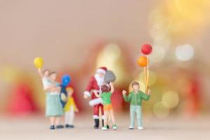 Miniature happy family celebrating Christmas, X-mas and Happy New Year concept photo