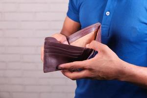 Man holding an empty wallet photo