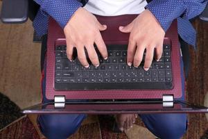 Typing on a laptop photo