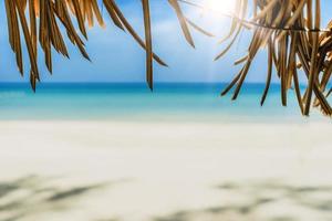Tropical beach with light blue sky background photo