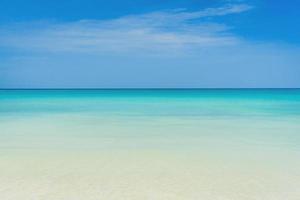 Tropical beach with light blue sky background photo