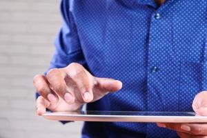 Man touching digital tablet photo