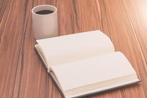 Open book and coffee cup on wooden table 3d render photo