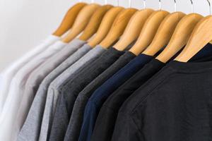 Close up of t-shirts on hangers, apparel background photo