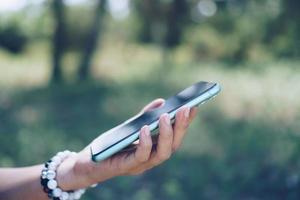 Woman's hand using a smartphone photo