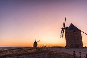 Old windmills at sunset photo