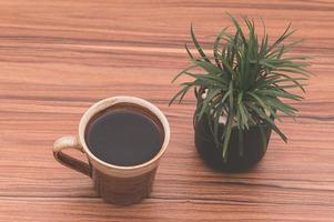Cup of coffee on wooden table photo