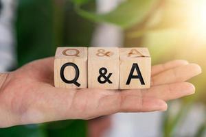 Q and A alphabet on wooden cubes in hand photo