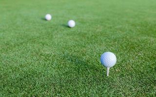 Golf balls on green grass photo
