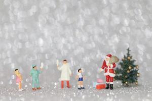 Miniature happy family celebrating Christmas, X-mas and Happy New Year concept photo