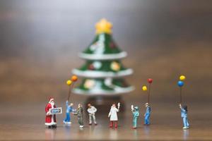 Miniature happy family celebrating Christmas, X-mas and Happy New Year concept photo