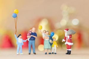 Miniature happy family celebrating Christmas, X-mas and Happy New Year concept photo