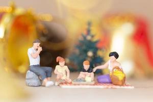 Miniature happy family celebrating Christmas, X-mas and Happy New Year concept photo