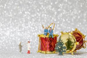 Miniature happy family celebrating Christmas, X-mas and Happy New Year concept photo