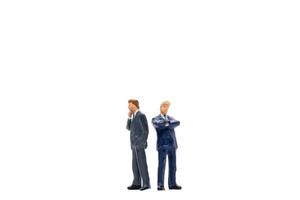 Miniature group of businessmen standing on a white background photo
