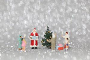 Miniature happy family celebrating Christmas, X-mas and Happy New Year concept photo