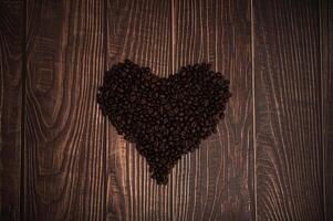 Coffee beans arranged in a heart shape photo