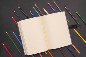 Book and colored pencils photo