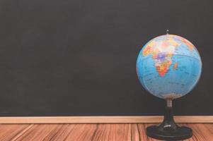 World globe against chalkboard