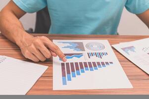 A man is looking at graphs on a paper photo