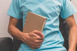 Man holding a book photo