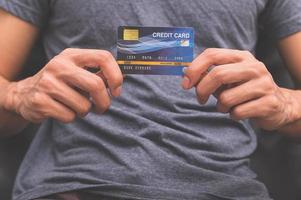 A man holding a credit card in his hand photo