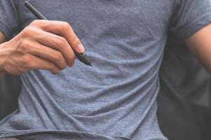 A man holding a pen photo