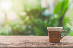 Coffee mug on the table with sunlight photo