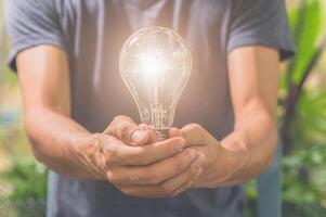 Idea of a man holding a light bulb photo